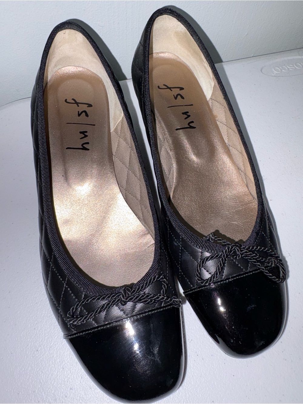 French Sole Black deluxe black leather Quilted Wedge Flats with Patent Cap Toe.